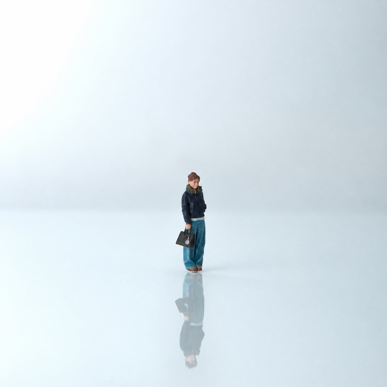 1:64 Everyday Winter Miniature Figure Series A - Standing Young Woman in Puffer Jacket Carrying a Bag Figure