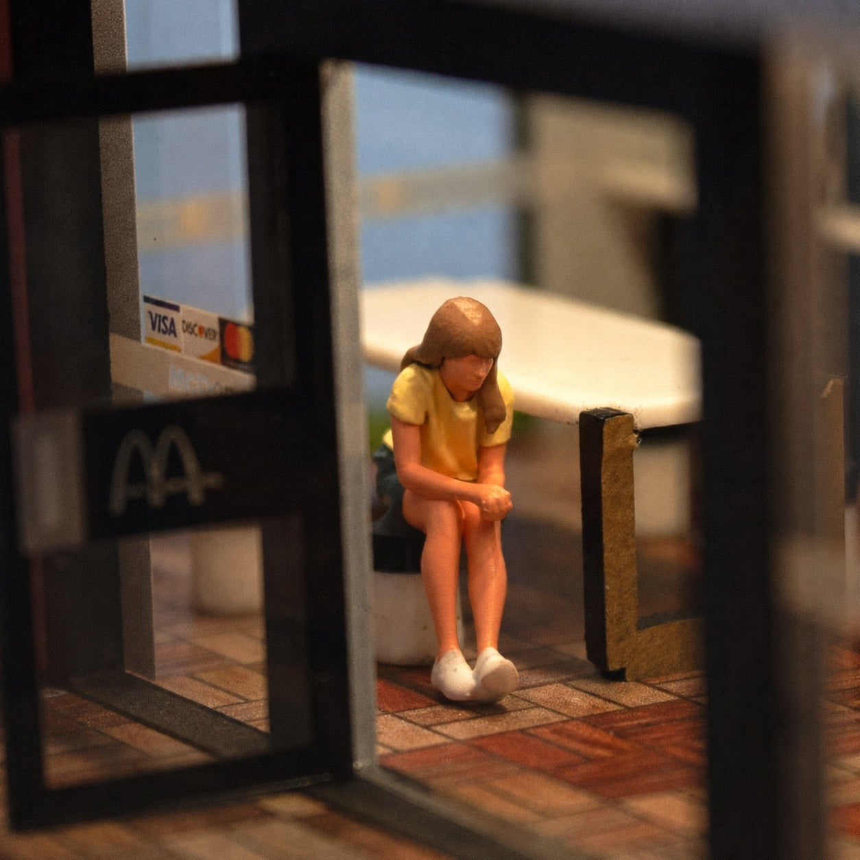 1:64 Everyday People Miniature Figure Series - Seated Woman in Yellow Top with Loose Hair Figure