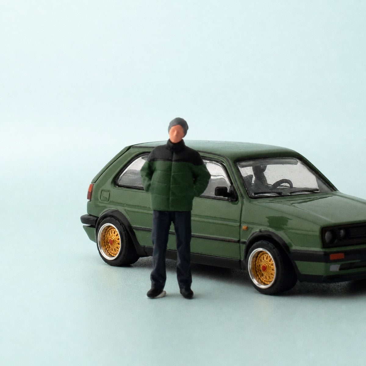 1:64 Everyday People Miniature Figure Series - Standing Man in Black & Green Puffer Jacket with Hands in Pockets Figure