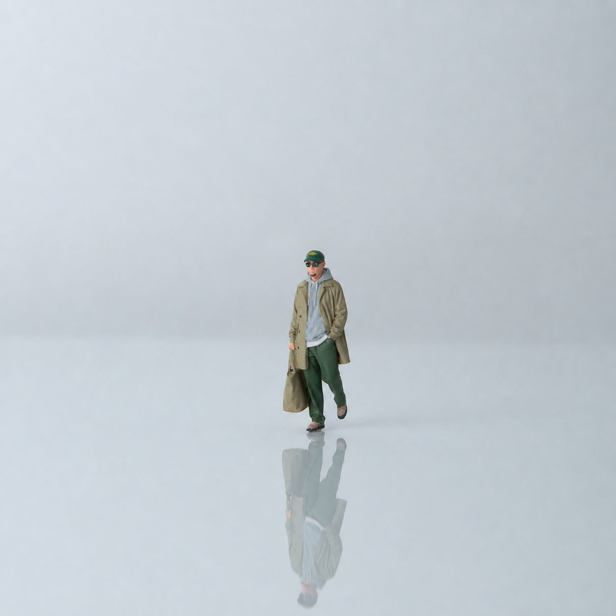 1:64 Everyday Winter Miniature Figure Series A - Walking Young Man in Trench Coat Carrying a Bag Figure